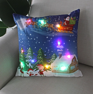 Detailed view of LED Christmas pillow case with Santa reindeer motif on a sofa