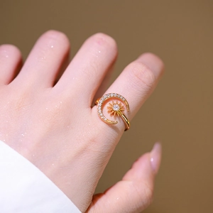 Exquisite gold sun and moon adjustable ring with pavé zircon stones on model's hand