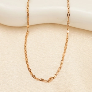 Elegant rose gold lip chain necklace made of stainless steel on beige satin fabric