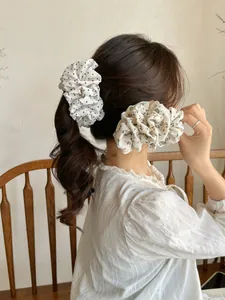 Detail view of large pleated scrunchies with black polka dots and floral patterns