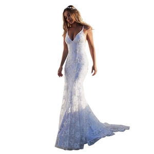 Detail of white floral lace embroidery and fishtail hem on elegant V-neck evening gown