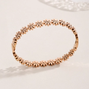 Polished rose gold stainless steel daisy bracelet with small clear zircon centers