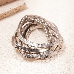 Detail of silver multilayer elastic snake bone chain bracelet with metallic texture