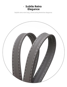 Detail of grey soft leather handle with precision stitching on a stylish large tote bag