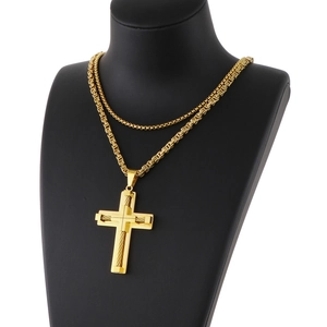 Detail of gold Byzantine chain with large cross pendant on black mannequin bust