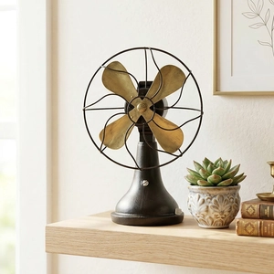 Industrial vintage metal electric fan decor on wooden shelf with retro ornaments