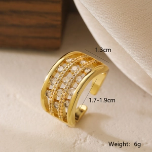 Macro view of gold-plated geometric ring with sparkling zircons on textured wood display