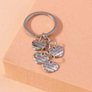 Retro silver metal keychain with engraved love you heart charms on a textured block