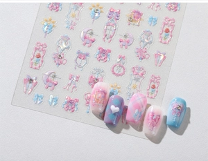 Detail of pink and purple bow nail art stickers with embossed holographic finish