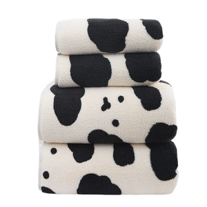 Soft coral fleece towel set with black and white cow print patterns in four sizes