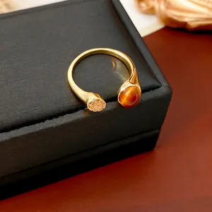 Irregular open ring with tiger eye stone and pavé zircon in luxurious gold finish