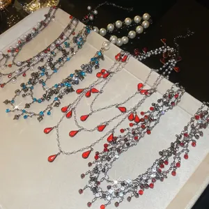 Elegant rhinestone pearl necklaces with red teardrop gemstones and blue crystals