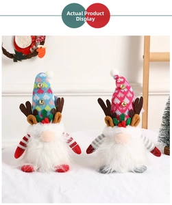 Close-up of glowing Christmas gnomes with knit reindeer hats and white fur beards
