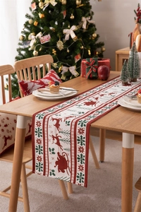 Detailed pattern of reindeer and snowflakes on Christmas table runner and pillow covers