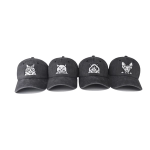 Detail of four washed charcoal baseball caps featuring white embroidered cat face designs