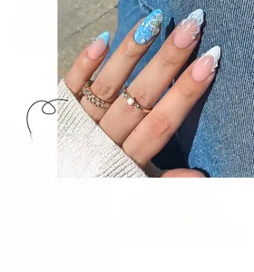 Detail of 3D shell texture and pearl accents on light blue French almond press-on nails