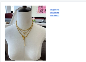 Three-layer gold stainless steel necklace set with butterfly charms on a white mannequin
