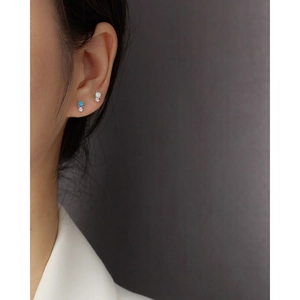 Minimalist S925 silver opal earrings set with tiny diamonds shown on a model's ear