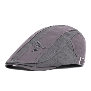 Detail view of cotton grey-purple cap with embroidered letter A and metal side buckle