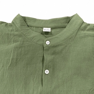 Close-up of green cotton shirt collar and button detail with size XXL label