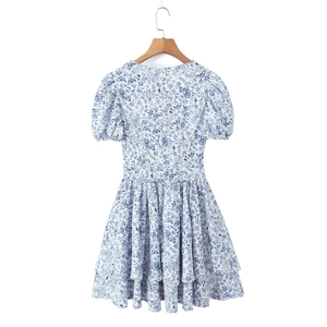Light blue floral French V-neck dress with puff sleeves and ruffled hem on a wooden hanger