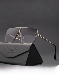 Detail of oversized square gradient sunglasses with gold metal frame and triangle case
