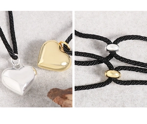 Detail view of S925 sterling silver heart pendants and adjustable black rope cord