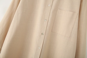 Close-up of linen texture, button placket and chest pocket on a beige casual shirt