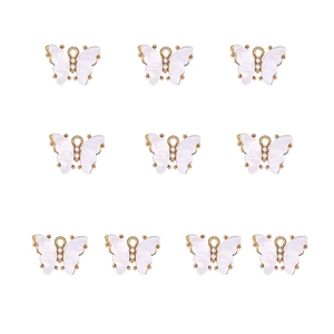 Macro shot of 10 white acrylic butterfly charms with gold alloy frame and small rhinestones