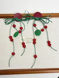 Detail of red and green Chinese knot tassel earrings with double joy characters