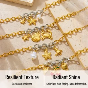 Detail of gold ocean charm bracelet featuring starfish, shells, and baroque pearls