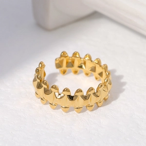 Adjustable golden stainless steel ring featuring a geometric gear style industrial design
