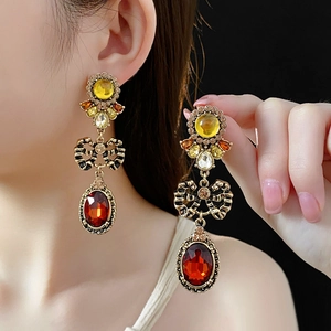 Detailed close-up of vintage bow earrings with colorful gemstones and bronze finish