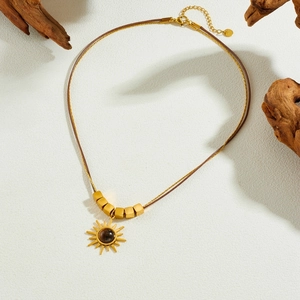 Bohemian gold sun pendant necklace with brown beads and tiger eye stone on wax cord