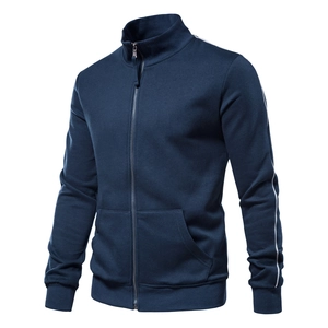 Detail of ribbed cuffs and white side stripes on a dark blue stand collar sports jacket