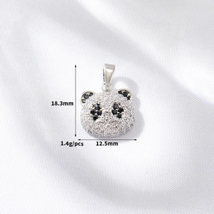 Macro shot of 14k gold-plated panda pendant with size specs and zircon inlay