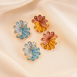 Floral enamel stud earrings with crystal rhinestones in blue and gold on satin