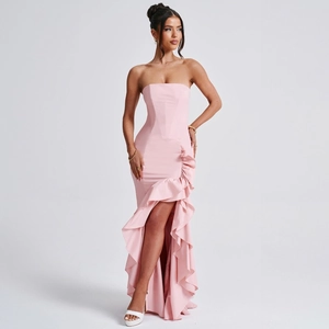 Detail of pink strapless evening dress featuring vertical ruffles and a high side slit