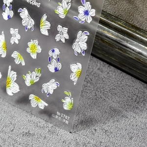 3D embossed camellia nail stickers with white petals and yellow centers on clear sheet