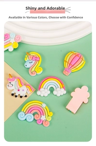 Flat lay of colorful resin DIY charms including unicorns and rainbows in pastel macaron colors