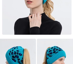 Detail showing the ponytail hole and leopard print pattern on blue knit beanie