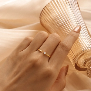 Macro detail of gold S925 silver adjustable ring with marquise zircon on champagne silk