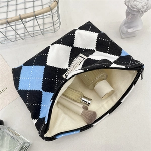 Top view of spacious checkered toiletry bag with zipper closure and smooth inner lining