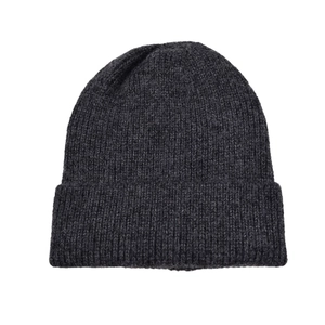 Detail of dark grey knit beanie showing thick ribbed texture and wool blend fabric