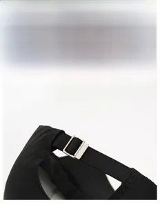 Close-up of the adjustable silver metal buckle on black athletic baseball cap back