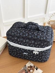 Quilted floral dark blue toiletry bag with elegant bow details and large capacity