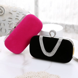 Detail of velvet evening bags in black and rose red with sparkling rhinestone clasps
