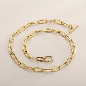 Detail of gold geometric rhombus link chain necklace with a decorative toggle clasp