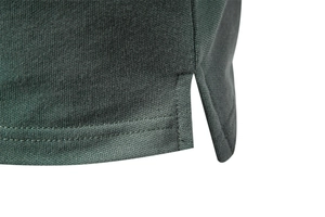 Macro shot of dark green piqué polo shirt side slit with durable double stitching
