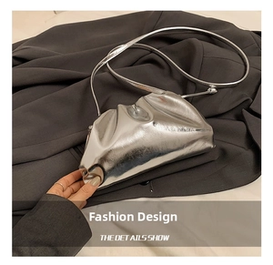 Detail showing the silver metallic mirror leather and ruched design of the cloud bag
